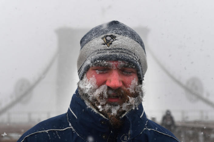 <p>A pedestrian walks through blinding snow across the Brooklyn Bridge during Storm Grayson in New York City, Jan. 4, 2018. (Photo: Darren Ornitz/Reuters) </p>