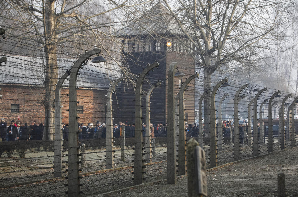 FILE-In this file photo taken Jan. 27, 2020, people are seen arriving at the site of the Auschwitz-Birkenau Nazi German death camp in Oswiecim, Poland, for observances marking 75 years since the camp's liberation by the Soviet army. The camp's museum is objecting to a scene in the Amazon series "Hunters" that shows a game of murderous human chess, saying such a game never took place there. (AP Photo/Czarek Sokolowski)