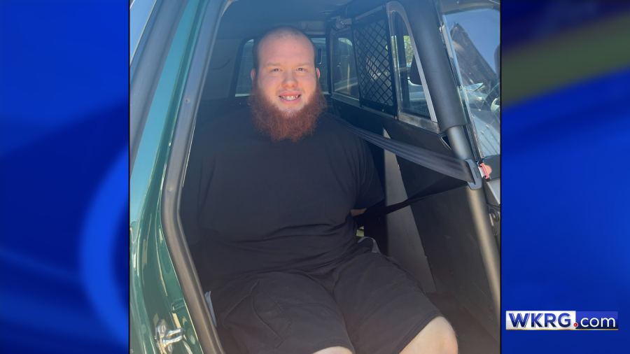 Thomas Wiessner, a bald man with a red beard, is seen handcuffed in an Escambia County Sheriff's Office patrol vehicle in Pensacola, Florida. 