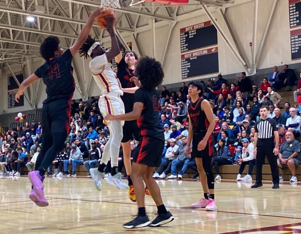 Clovis West’s DJ Stickman is defended by several San Joaquin Memorial players during its Central Section Division I quarterfinal game on Thursday, Feb. 15, 2024.