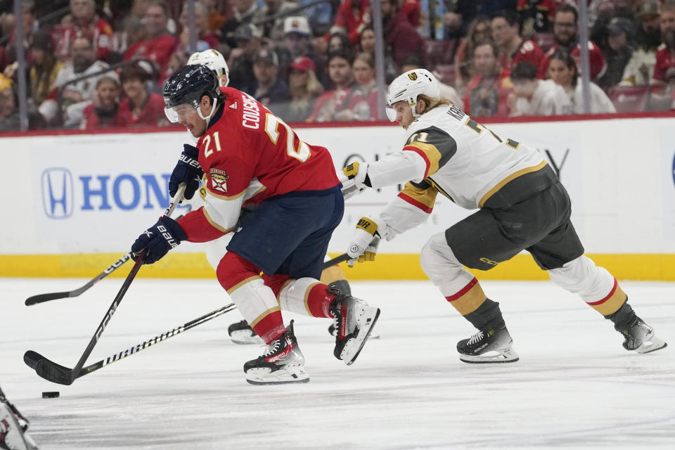 Florida Panthers center Nick Cousins (21) skates with the puck as Vegas Golden Knights center William Karlsson defends during the first period of an NHL hockey game, Saturday, Dec. 23, 2023, in Sunrise, Fla. (AP Photo/Lynne Sladky)