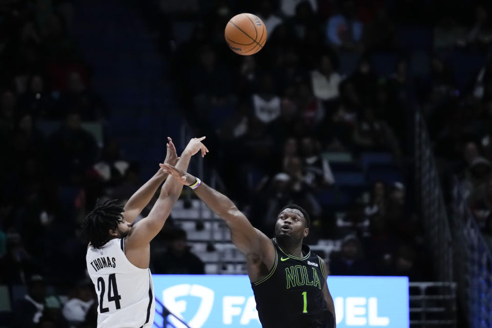 Brooklyn Nets guard Cam Thomas (24) shoots against New Orleans Pelicans forward Zion Williamson (1) in the second half of an NBA basketball game in New Orleans, Tuesday, Jan. 2, 2024. The Pelicans won 112-85. (AP Photo/Gerald Herbert)