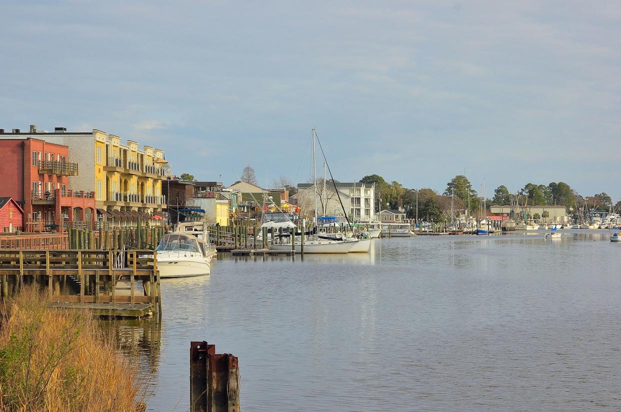 Georgetown SC harbor with colorful buildings with fishing boats, sailboats and recreational boats moored