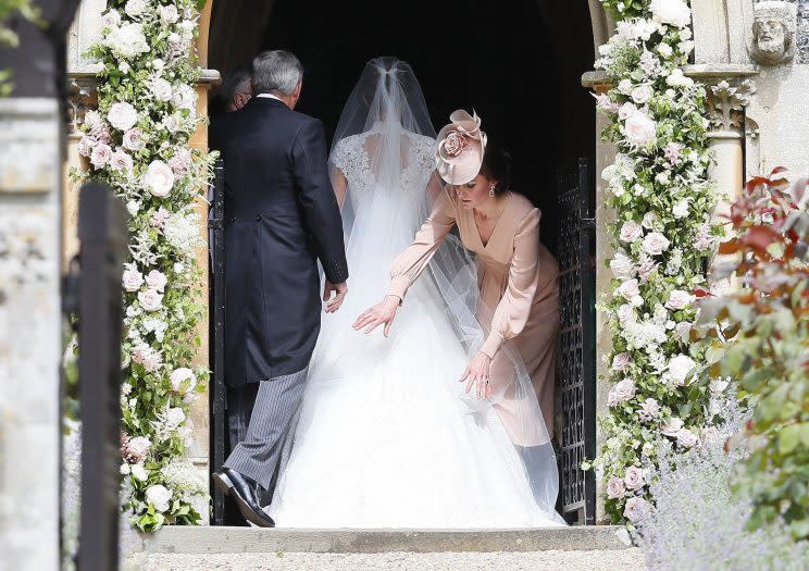 <i>Is Kate a bridesmaid? She was seen adjusting Pippa’s dress [Photo: PA]</i>