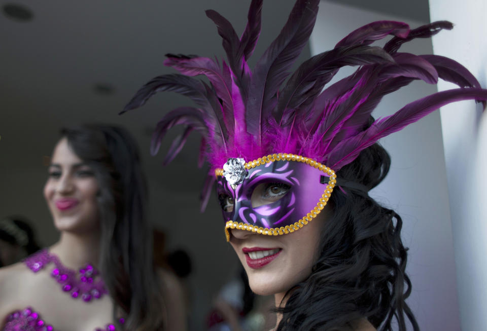 In this photo taken Thursday, May 1, 2014, two models prepare backstage to display a creation by designer Fayzeh Pearl ahead the opening day of the Palestine Fashion Week 2014, in the West Bank city of Ramallah. The three-day show, which ended Saturday, May 3, 2014, saw models prowl the catwalk in the only major fashion show in the Palestinian territories. (AP Photo/Nasser Nasser)