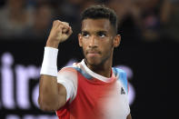 Felix Auger-Aliassime of Canada reacts after winning the second set against Daniil Medvedev of Russia during their quarterfinal match at the Australian Open tennis championships in Melbourne, Australia, Wednesday, Jan. 26, 2022. (AP Photo/Andy Brownbill)