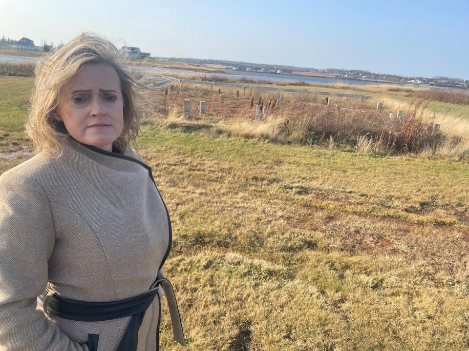 Stephanie Bonnell stands next to what is left of her home in the Hebrides. 