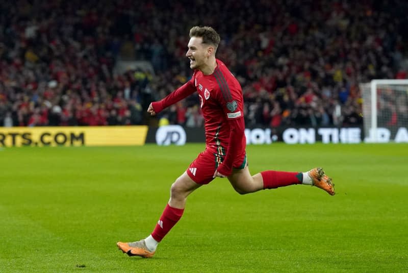 Wales' David Brooks celebrates scoring his first goal during the UEFA Euro 2024 Qualifying play-off soccer match between Wales and Finland at the Cardiff City Stadium. Nick Potts/PA Wire/dpa