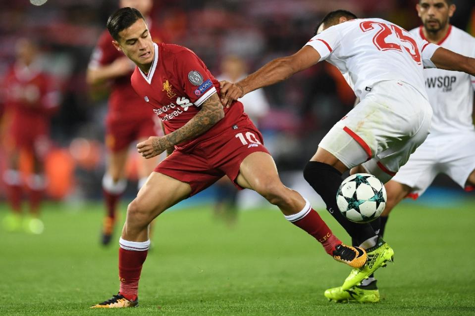 Liverpool midfielder Philippe Coutinho (L) managed 14 minutes in the Champions League against Sevilla. (AFP Photo/Paul ELLIS)