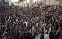 Supporters of Tehreek-e-Labaik Pakistan, a radical Islamist political party, chant religious slogans during a sit-in protest demanding release of their leader Saad Rizvi, in Lahore, Pakistan, Thursday, Oct. 21, 2021. Thousands of Islamists are demanding the release of Rizvi, who was arrested in April amid protest against France over depictions of Islam's Prophet Muhammad. (AP Photo/K.M. Chaudary)