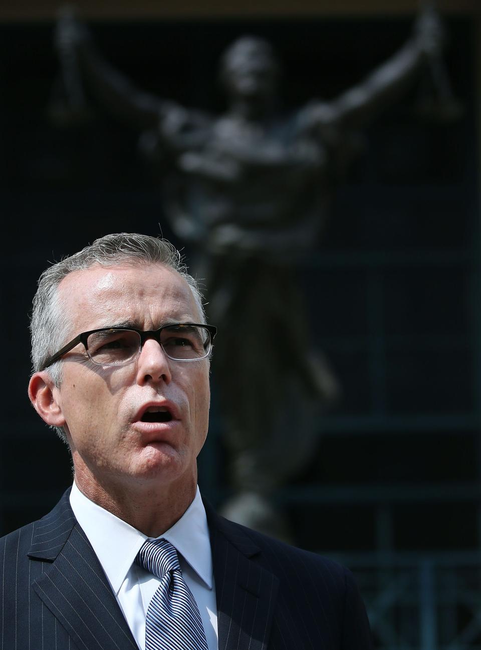 Former FBI deputy director Andrew McCabe speaks to the media after a hearing in federal court June 11, 2015 in Alexandria, Va.