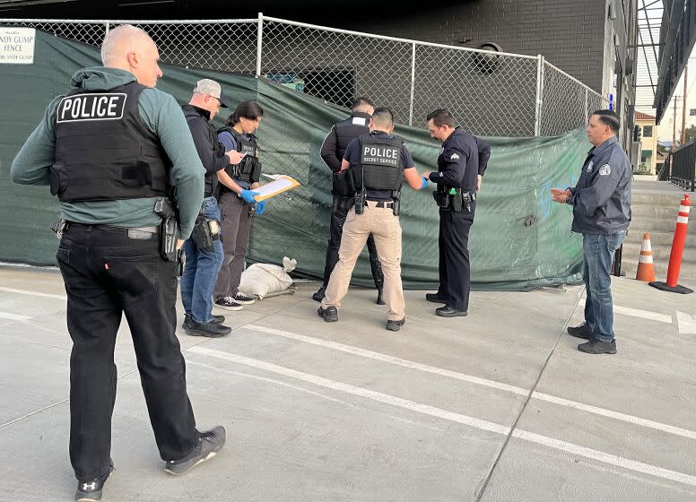 TARZANA CA FEBRUARY 2, 2023 - LAPD and federal officers make an arrested Thursday morning, Feb. 2, 2023 for alleged EBT fraud at a US Bank ATM in Tarzana. Victims had reported their EBT cards had been drained of funds at the ATM near the first of every month. (Rebecca Ellis / Los Angeles Times)