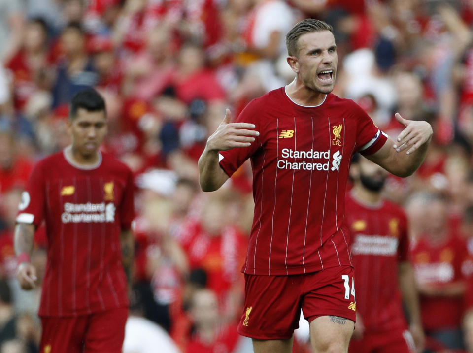 Liverpool's Jordan Henderson celebrates after the English Premier League soccer match between Liverpool and Arsenal at Anfield stadium in Liverpool, England, Saturday, Aug. 24, 2019. (AP Photo/Rui Vieira)