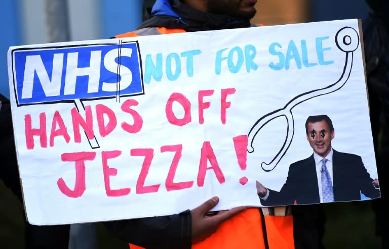 Demonstrators stand with placards at Salford Royal Hospital in Manchester, northwest England, during a 24-hour strike over pay and conditions on February 10, 2016