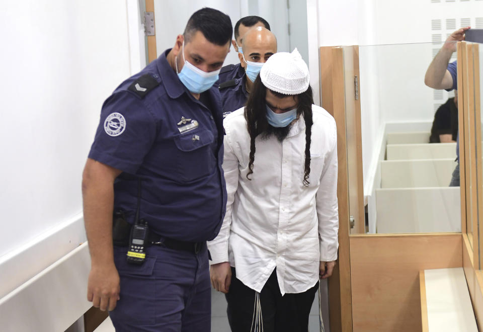 FILE - Israeli Jewish extremist Amiram Ben-Uliel arrives in court in Lod, Israel, on May 18, 2020, where he was convicted in a 2015 arson attack that killed a Palestinian toddler and his parents in the West Bank. An Israeli group raising funds for Jewish radicals convicted in some of the country’s most notorious hate crimes, including Ben-Uliel, is collecting tax-exempt donations from Americans, according to an investigation by the AP and the Israeli investigative platform Shomrim. (Avshalom Sassoni/Pool Photo via AP, File)
