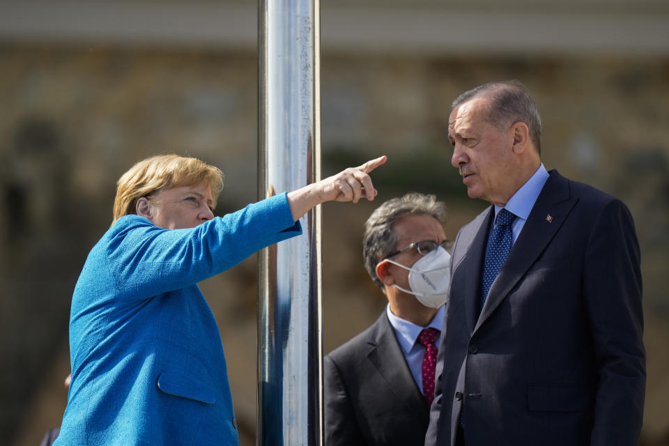 German Chancellor Angela Merkel, left, talks to Turkish President Recep Tayyip Erdogan on the occasion of their meeting at Huber Villa presidential palace, in Istanbul, Turkey, Saturday, Oct. 16, 2021. (AP Photo/Francisco Seco)