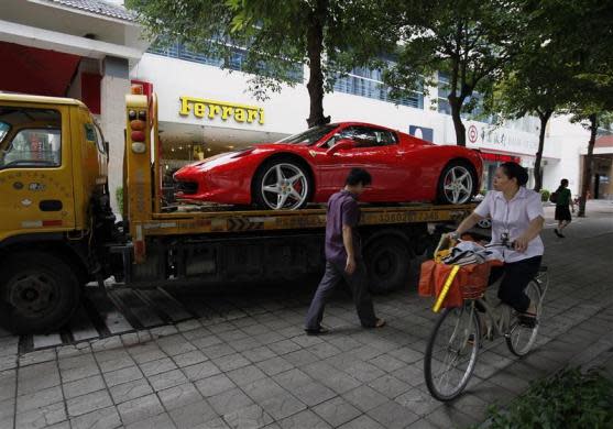 A Ferrari 458 Spider is loaded onto a truck after being bought by a young Chinese at its showroom in Shenzhen May 28, 2012.