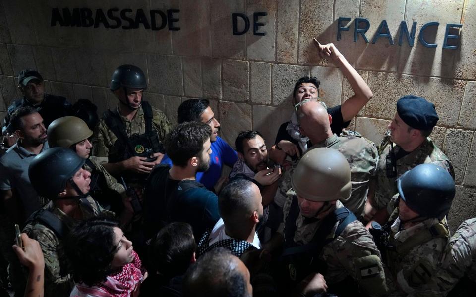 Demonstrators clash with the Lebanese army and riot police as they try to enter the French embassy during a protest in solidarity with the Palestinian people in Gaz