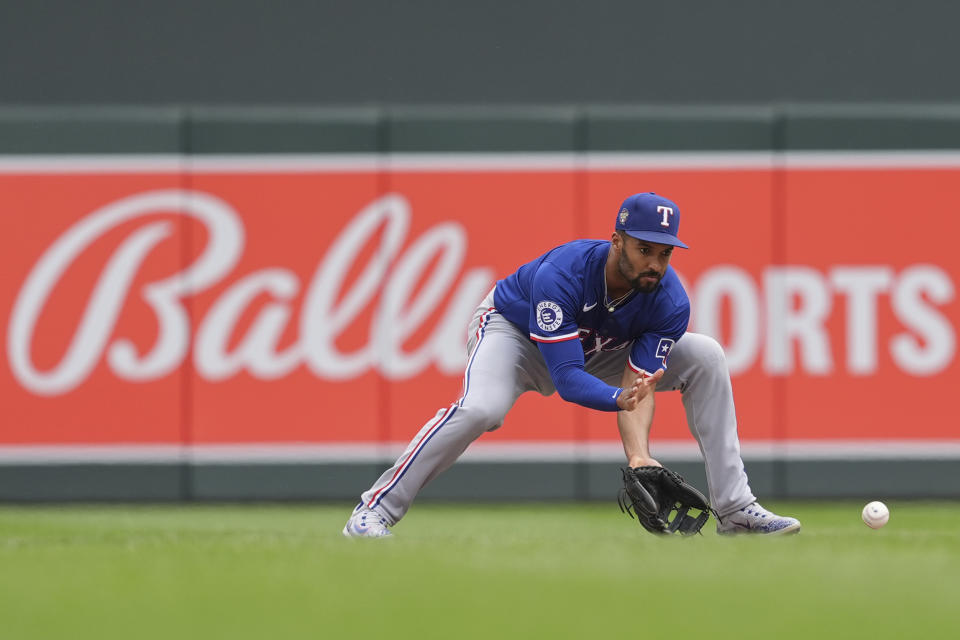 Texas Rangers second baseman Marcus Semien (2) fields a groundout hit by Minnesota Twins' Carlos Santana to force the final out of a baseball game Sunday, May 26, 2024, in Minneapolis. (AP Photo/Abbie Parr)