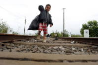 A Syrian migrant child walks along a railway track after crossing the Hungarian-Serbian border into Hungary, near Roszke, August 26, 2015. REUTERS/Laszlo Balogh