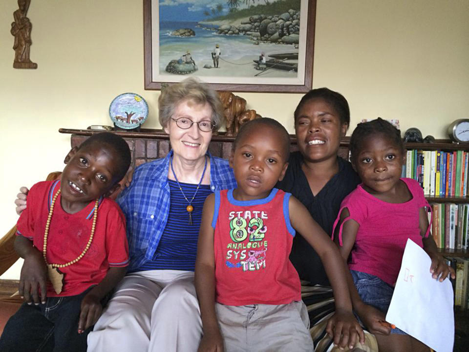 This 2018 photo provided by the Maryknoll Sisters shows Sister Janice McLaughlin with children in Zimbabwe. McLaughlin, a nun who was jailed and later deported by white minority-ruled Rhodesia, later Zimbabwe, for exposing human rights abuses, died on March 7, 2021, in Maryknoll, N.Y. She was 79. (Maryknoll Sisters via AP)