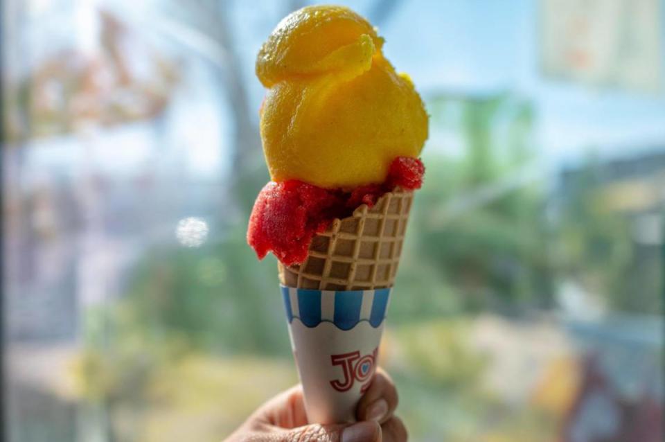 This ice cream cone includes scoops of mango sorbet and strawberry sorbet.