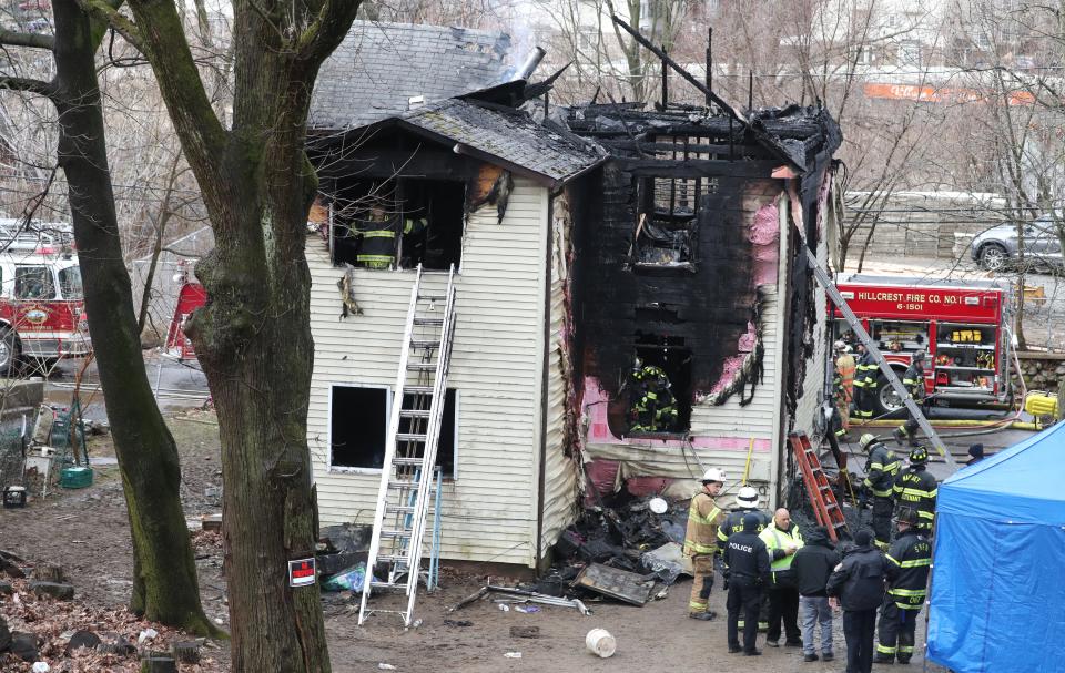 Firefighters work at the scene of an early morning fire on Lake St. in Spring Valley March 4, 2023. Five people died in the fire.