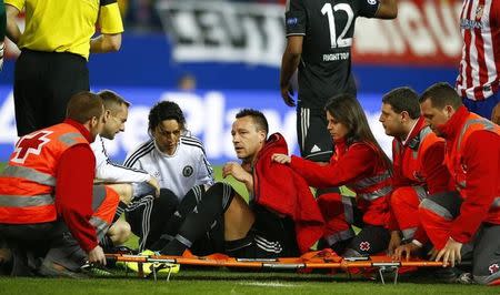 Chelsea's captain John Terry sits on a stretcher after being injured during their Champion's League semi-final first leg soccer match against Atletico Madrid at Vicente Calderon stadium in Madrid, April 22, 2014. REUTERS/Darren Staples