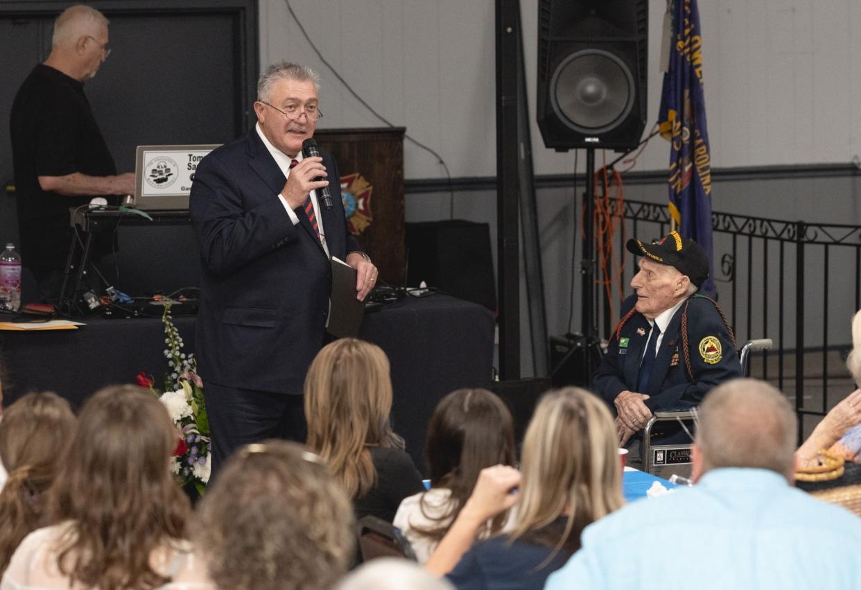 Donnie Loftis, a member of the North Carolina House of representatives, speaks to the crowd in attendance at Ray Stewart's 100th birthday party.