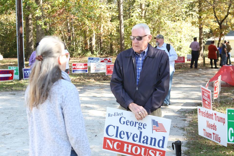 George Cleveland speaks with a voter at Pine Valley United Methodist Church as folks turned out to vote Tuesday, 2 November 2020.  [John Althouse / The Daily News]