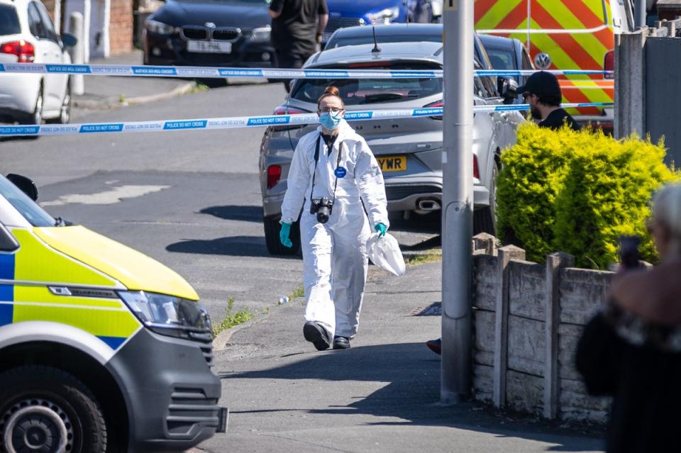 A forensics officer at the scene yesterday (PA)