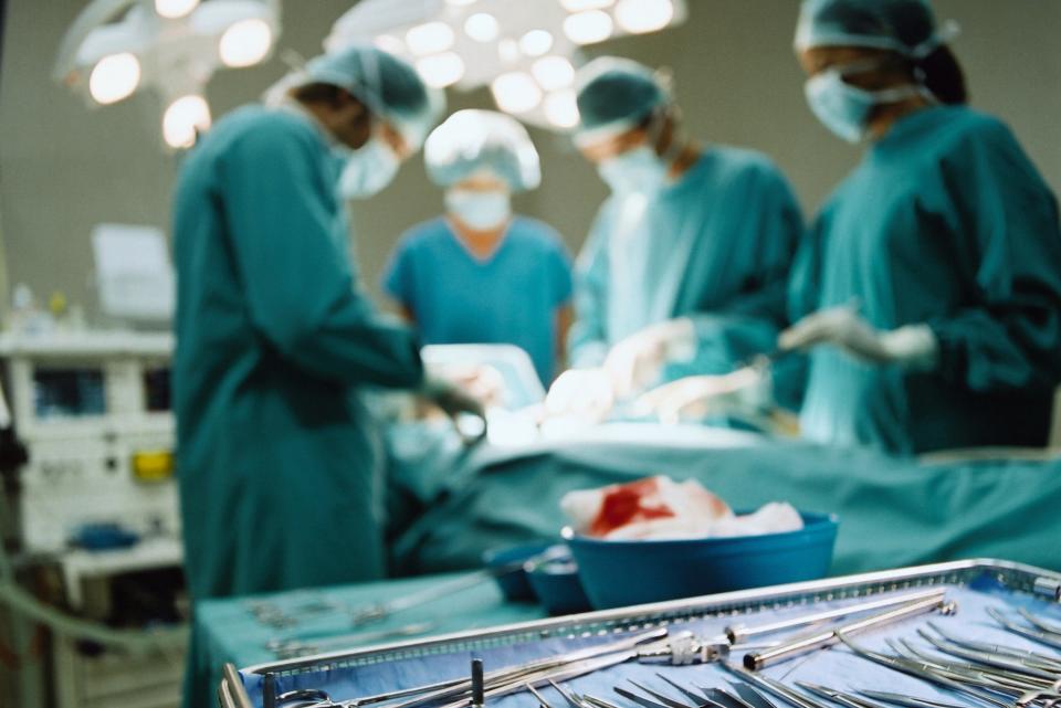 Medical workers performing surgery on a patient