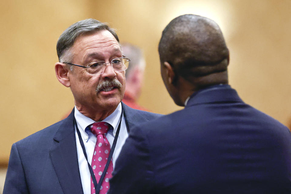 Arizona Representative Mark Finchem speaks with Bennie Smith, commissioner from Shelby County (TN) before an Election Conspiracy Forum event hosted by Tennessee Stands Saturday, March 11, 2023, in Franklin, Tenn. (AP Photo/Wade Payne)