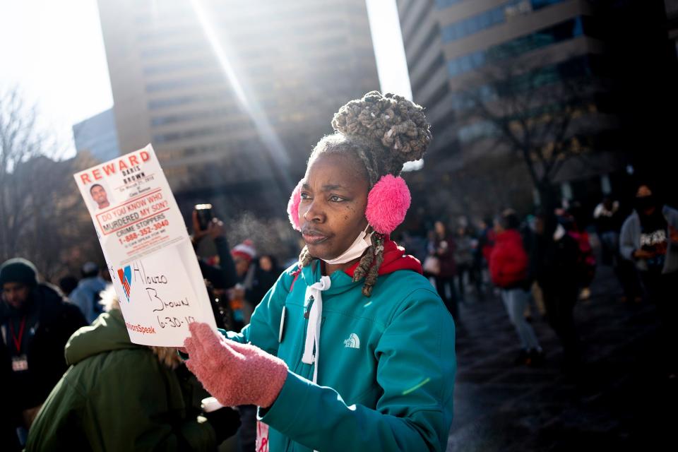 LaTosha Brown, of Cincinnati, holds up a sign with the names of her two sons, both of whom were victims of homicide. She was among the participants Wednesday in the Survivors Speak Ohio event at the statehouse organized by Crime Survivors for Safety and Justice.