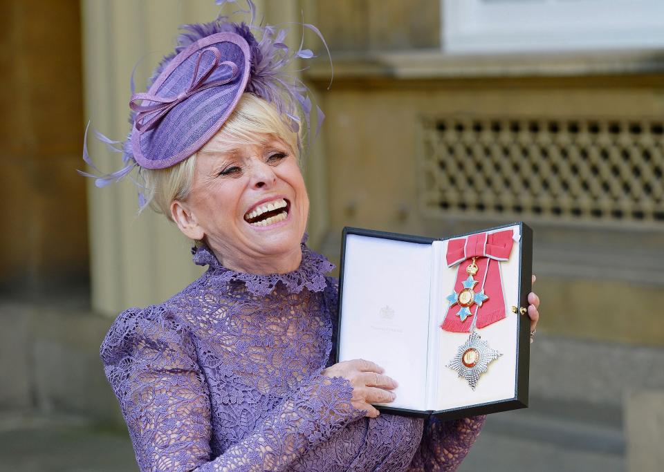 British actress Barbara Windsor poses with her insignia after being appointed a Dame Commander of the order of the British Empire (DBE) at an investiture ceremony at Buckingham Palace in London on March 22, 2016. / AFP / POOL / John Stillwell        (Photo credit should read JOHN STILLWELL/AFP via Getty Images)