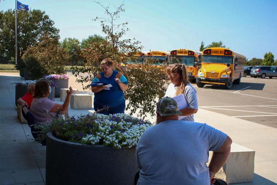 Hungate meets with other bus drivers to go over the upcoming week's schedule.