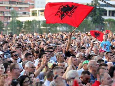 A supporter of the Socialist Party waves his flag during a post-elections rally in Tirana, Albania June 27, 2017. REUTERS/Florion Goga