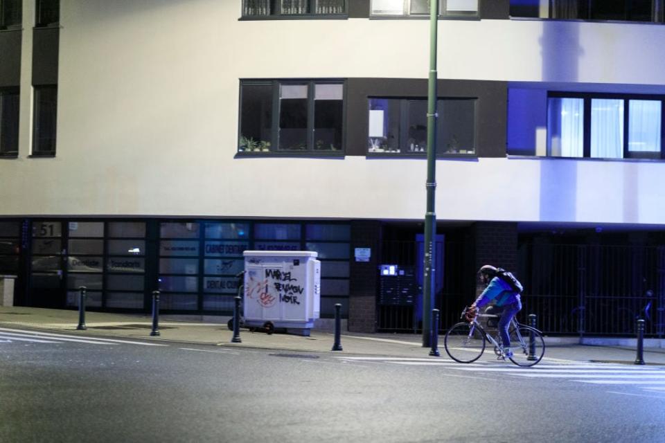 A cyclist rushes home to beat the curfew in Brussels - getty