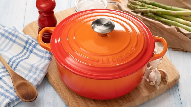 Dutch oven with lid on cooking board