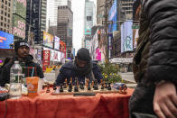 Tunde Onakoya, 29, a Nigerian chess champion and child education advocate, plays a chess game in Times Square, Friday, April 19, 2024 in New York. (AP Photo/Yuki Iwamura)