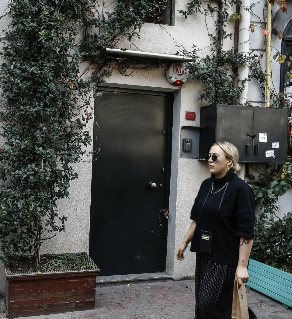A woman walks past the house of British army officer James Le Mesurier who helped found the "White Helmets" volunteer organization in Syria, in Istanbul, Wednesday, Nov. 13, 2019. The Istanbul chief prosecutor's office said Tuesday an autopsy and other procedures were underway at Istanbul's Forensic Medicine Institute to determine "the exact cause" of Le Mesurier's death.(AP Photo/Emrah Gurel)