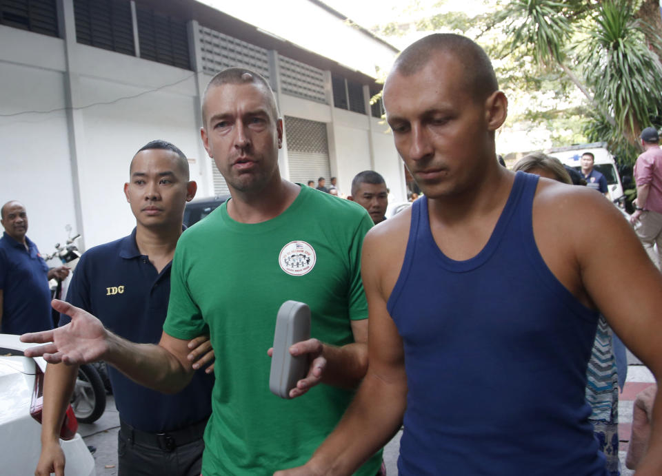 Russian self-styled sex guru Alexander Kirillov, second from right, is escorted by Thai Immigration police officers from the Immigration Detention Center towards a vehicle to take him to an airport for deportation, in Bangkok, Thailand, Thursday, Jan. 17, 2019. Kirillov was arrested for holding a sex training seminar in Pattaya, Thailand, in February 2018. (AP Photo/Sakchai Lalit)