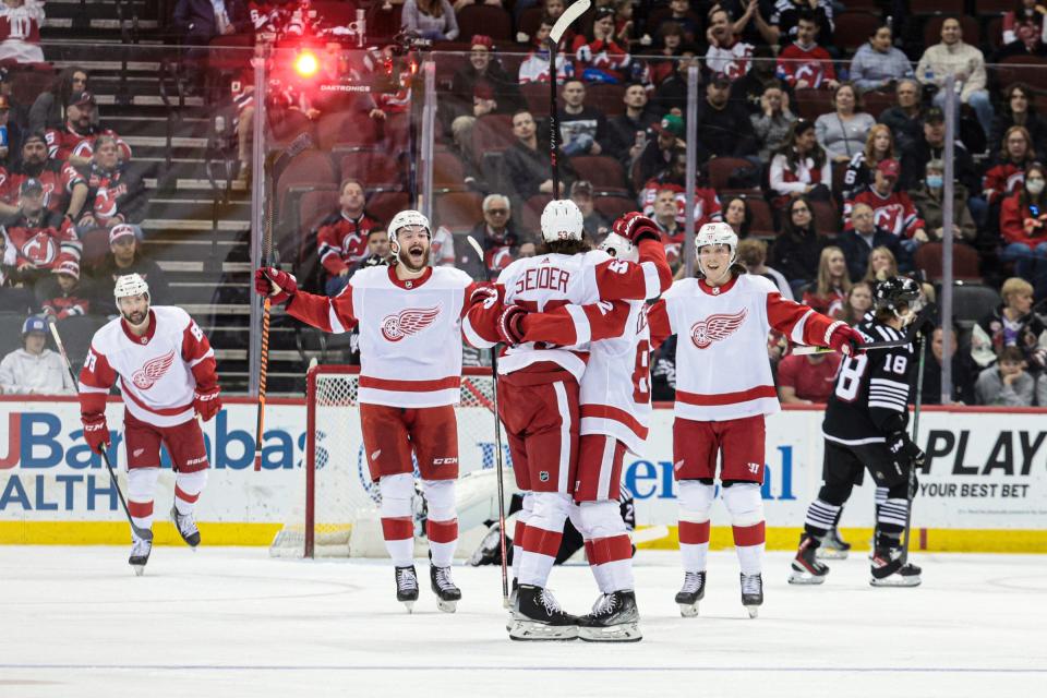 Detroit Red Wings defenseman Moritz Seider (53) celebrates his goal with teammates during the second period against the New Jersey Devils at the Prudential Center in Newark, N.J., on Friday, April 29, 2022.