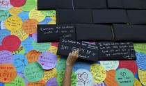 A participant puts up a sign about his sexuality before taking part in the forming of a giant pink dot at the Speakers' Corner in Hong Lim Park in Singapore June 29, 2013. REUTERS/Edgar Su/File Photo