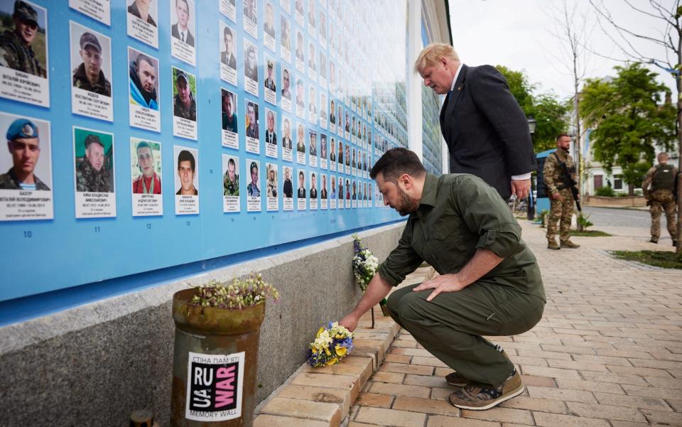 Prime Minister Boris Johnson and President Volodymyr Zelensky lay flowers at the Memory Wall of Fallen Defenders of Ukraine, in front of the St. Michael's Golden-Domed Cathedral (Mykhailivskyi Zolotoverkhyi) in Kyiv on June 17, 2022.  - Ukrainian Presidential Press Service/Reuters