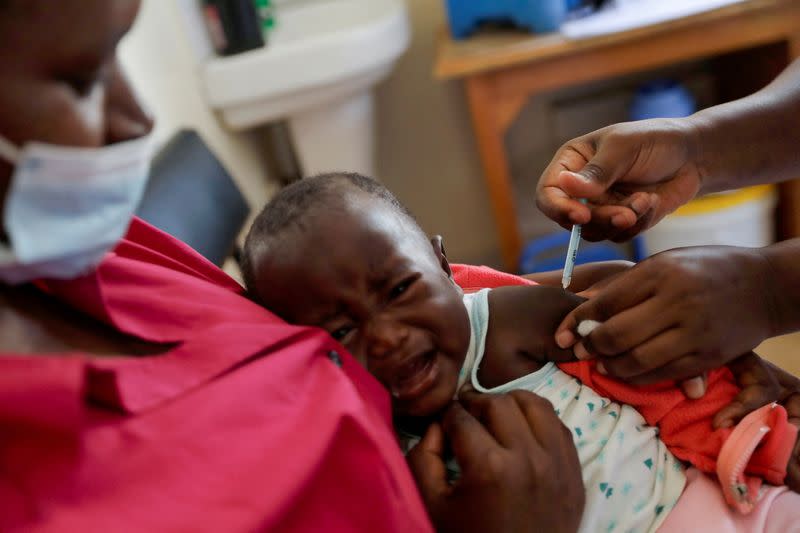 A nurse administers the malaria vaccine to an infant at the Lumumba hospital in Kisumu