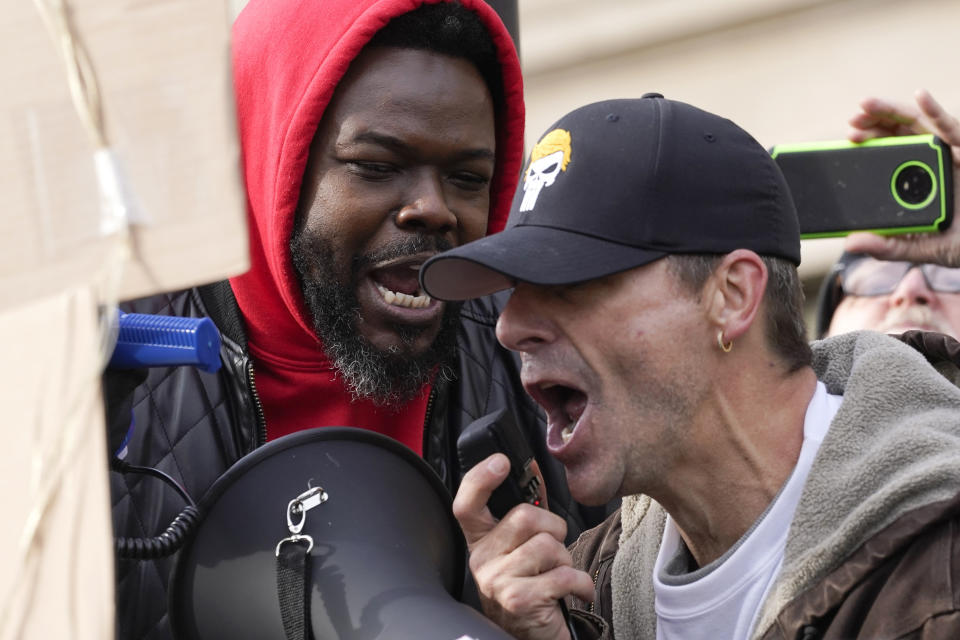 Protesters confront each other outside the Kenosha County Courthouse, Tuesday, Nov. 16, 2021, in Kenosha, Wis., during the Kyle Rittenhouse murder trial. Rittenhouse is accused of killing two people and wounding a third during a protest over police brutality in Kenosha, last year. (AP Photo/Paul Sancya)