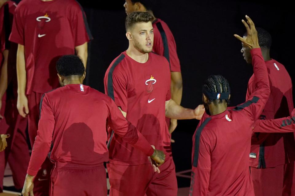 Meyers Leonard greets his Miami Heat teammates before a game against the Milwaukee Bucks on Dec. 29, 2020.