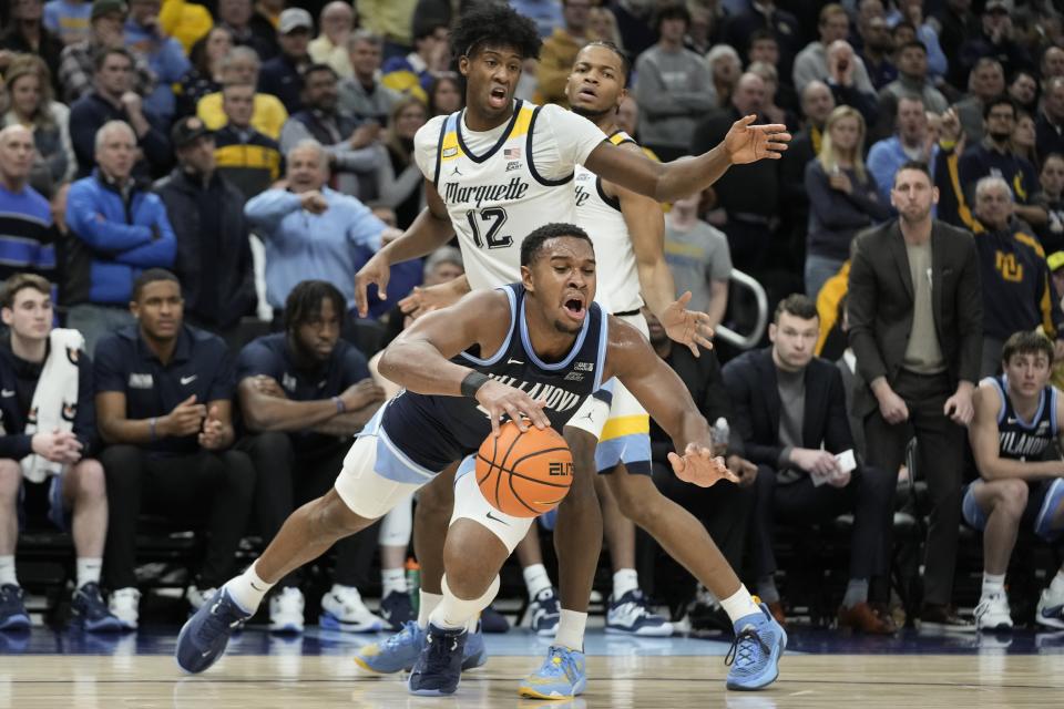 Villanova's Eric Dixon loses the ball in front of Marquette's Olivier-Maxence Prosper during the second half of an NCAA college basketball game Wednesday, Feb. 1, 2023, in Milwaukee. Marquette won 73-64. (AP Photo/Morry Gash)