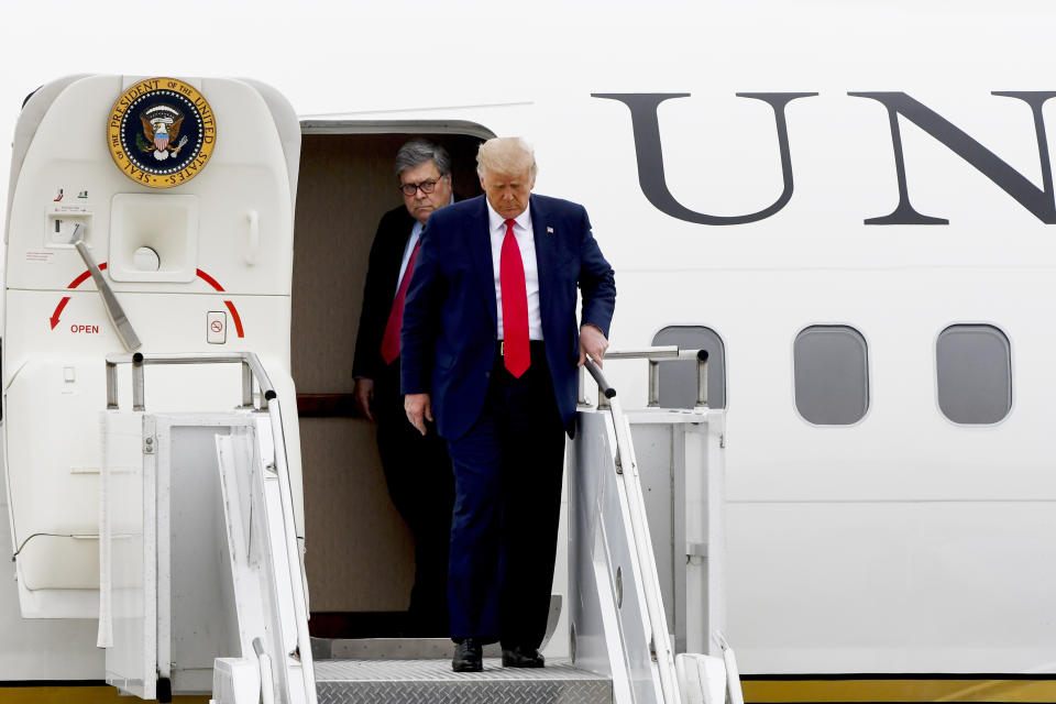 President Donald Trump and Attorney General William Barr, walk from Air Force One as he arrives at Waukegan National Airport before attending a series of events in Kenosha, WI, Tuesday, Sept. 1, 2020, in Waukegan, IL. (AP Photo/Matt Marton)